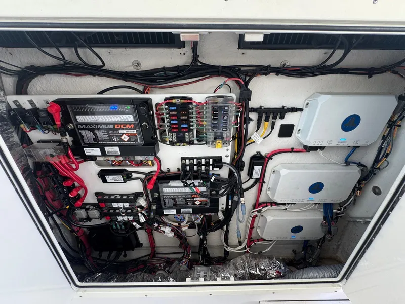 Slide: The Image of 2020 Sportsman Open 352 Center Console boat with seating and controls at a marina. - 15