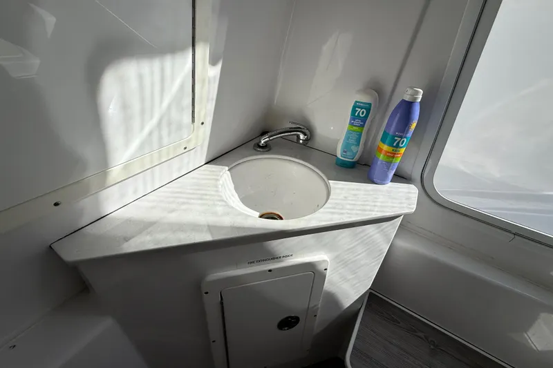 Slide: The Image of 2020 Sportsman Open 352 Center Console sink area with sunscreen bottles. - 29