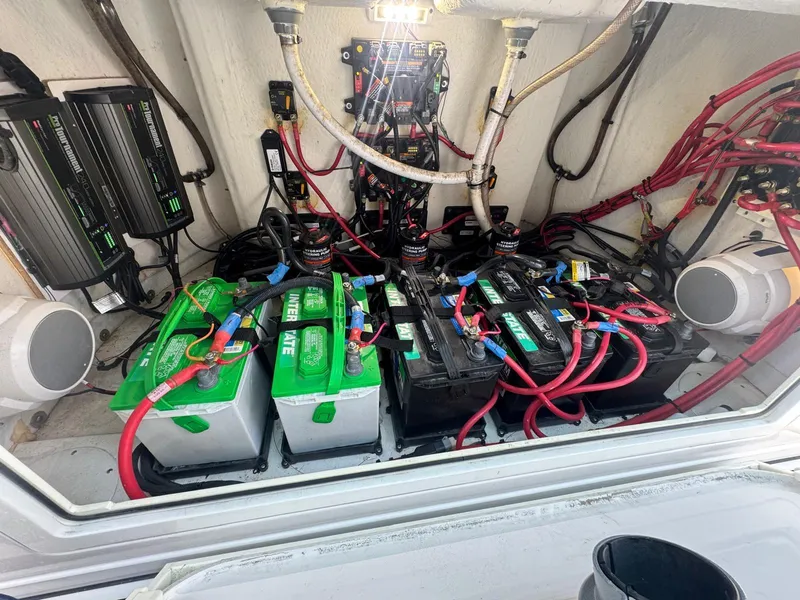 Slide: The Image of Battery compartment of a 2020 Sportsman Open 352 Center Console with wiring and chargers. - 35
