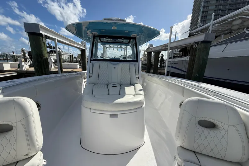 Slide: The Image of 2020 Sportsman Open 352 Center Console boat with white seating, docked under blue sky. - 39