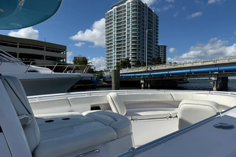 Slide: The Image of 2020 Sportsman Open 352 Center Console boat docked near a bridge and high-rise building. - 43