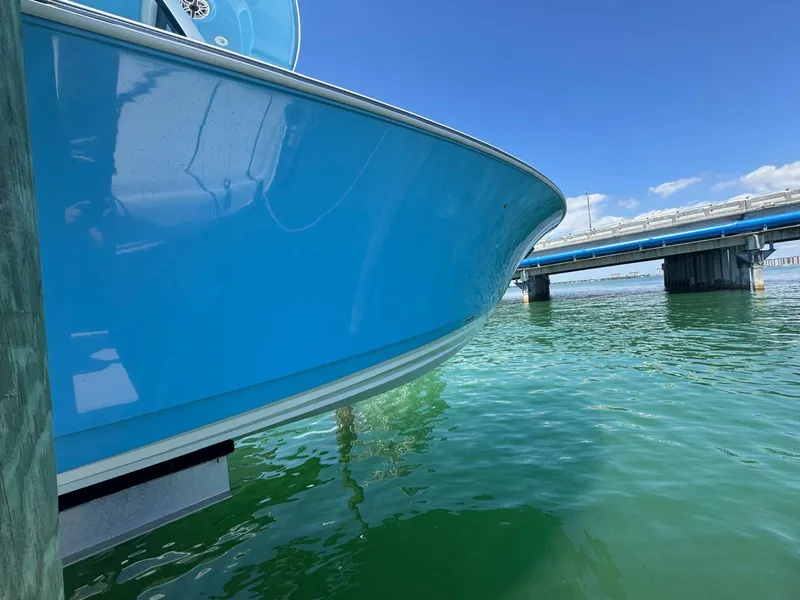 Slide: The Image of 2020 Sportsman Open 352 Center Console boat near a bridge over clear water. - 47
