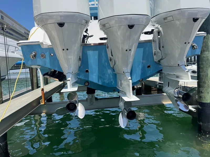 Slide: The Image of 2020 Sportsman Open 352 Center Console boat with triple outboard engines at dock. - 49