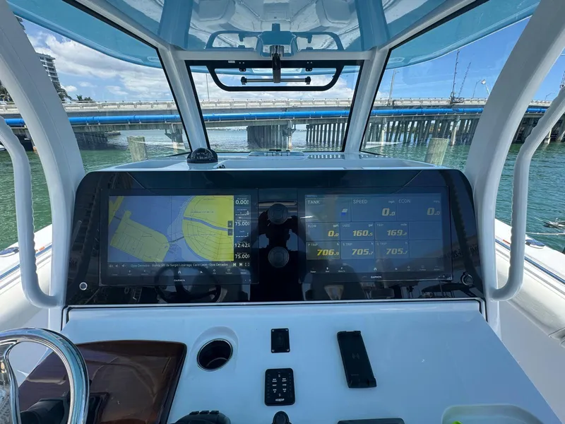 Slide: The Image of 2020 Sportsman Open 352 Center Console boat docked, featuring spacious deck and triple engines. - 5