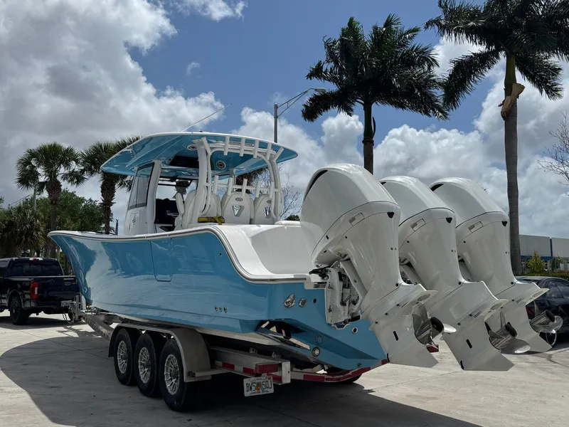 Slide: The Image of 2020 Sportsman Open 352 Center Console boat with triple engines on a trailer. - 53