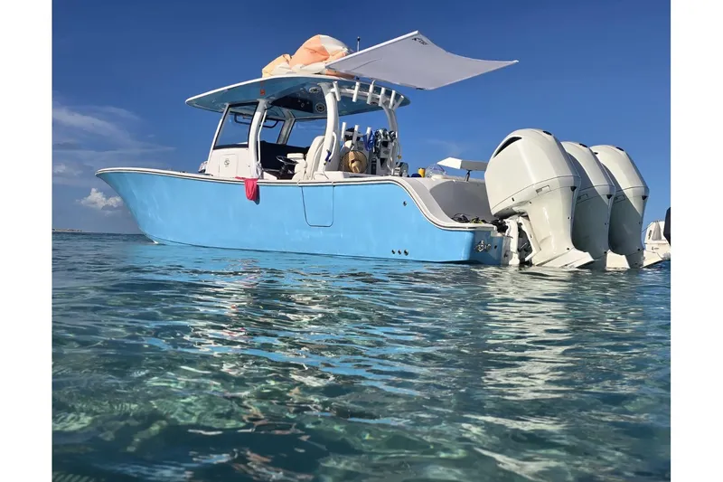 Slide: The Image of 2020 Sportsman Open 352 Center Console boat on clear water under blue sky. - 55