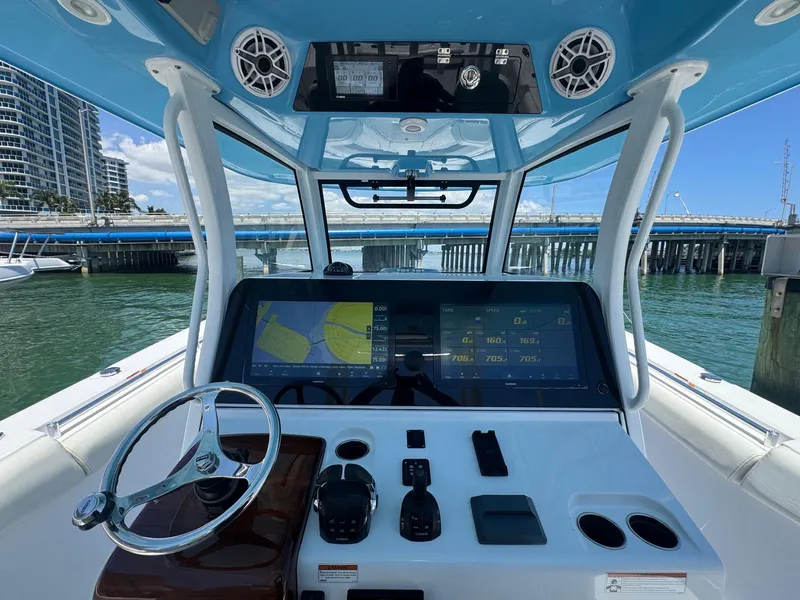 Slide: The Image of 2020 Sportsman Open 352 Center Console boat docked at marina, featuring spacious deck layout. - 6