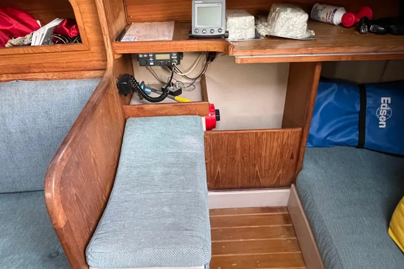 Slide: The Image of Interior of a 1987 Newport 30-3 sailboat with navigation equipment and seating. - 12