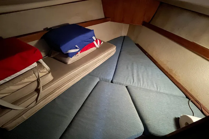 Slide: The Image of Cozy cabin interior of 1987 Newport 30-3 sailboat with cushions and storage. - 14