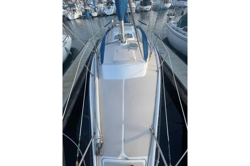 Slide: The Image of 1987 Newport 30-3 sailboat docked in marina, top view of deck and rigging. - 19