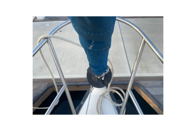 Slide: The Image of Bow view of 1987 Newport 30-3 sailboat with blue sail cover and railing. - 21