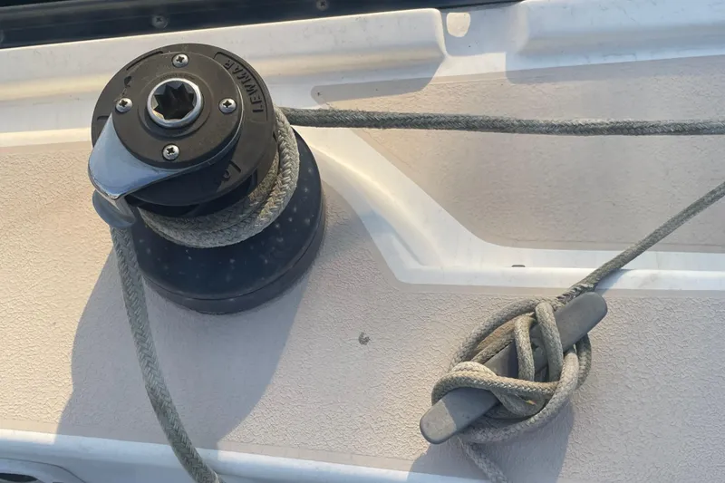 Slide: The Image of Winch and cleat on 1987 Newport 30-3 sailboat deck with rope. - 23
