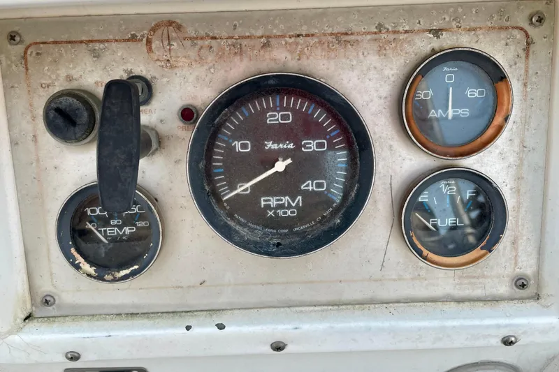 Slide: The Image of 1987 Newport 30-3 boat dashboard with RPM, temperature, amps, and fuel gauges. - 25