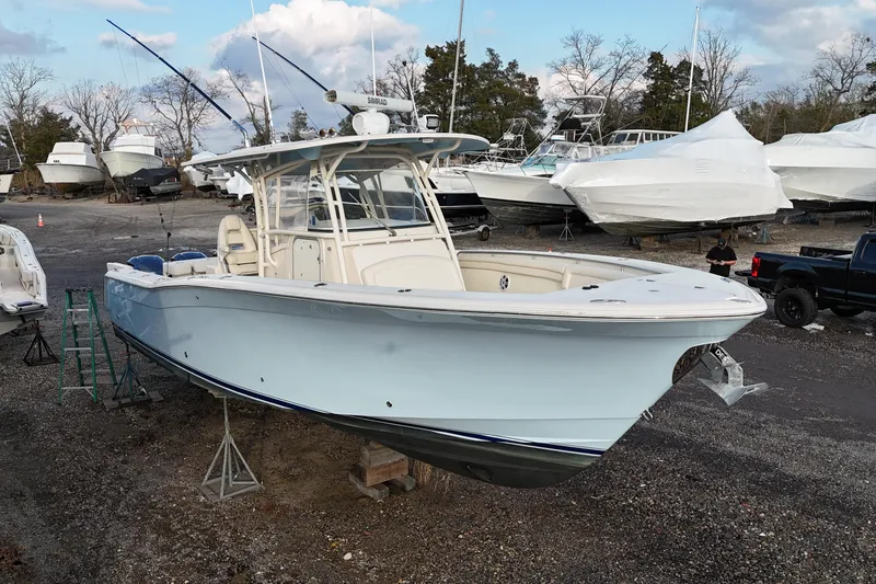 Slide: The Image of 2017 Grady-White Canyon 336 boat on dry dock, surrounded by other vessels. - 10