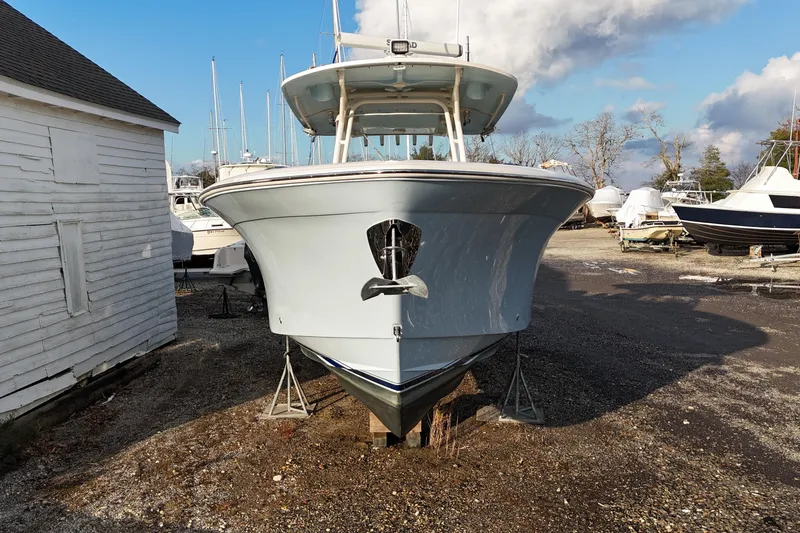 Slide: The Image of 2017 Grady-White Canyon 336 boat on dry dock, front view, clear sky background. - 11