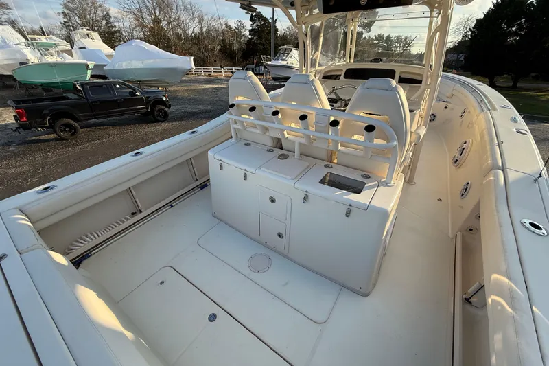 Slide: The Image of 2017 Grady-White Canyon 336 boat interior with seating and storage, parked outdoors. - 13