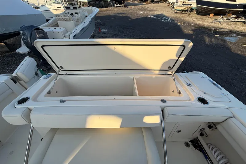 Slide: The Image of 2017 Grady-White Canyon 336 boat with open storage compartment, docked outdoors. - 15