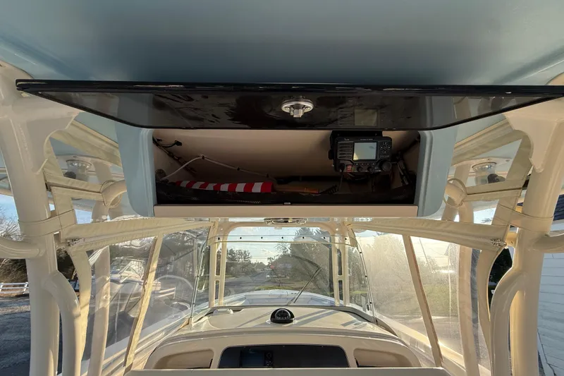 Slide: The Image of 2017 Grady-White Canyon 336 boat interior with electronics and storage compartment. - 19