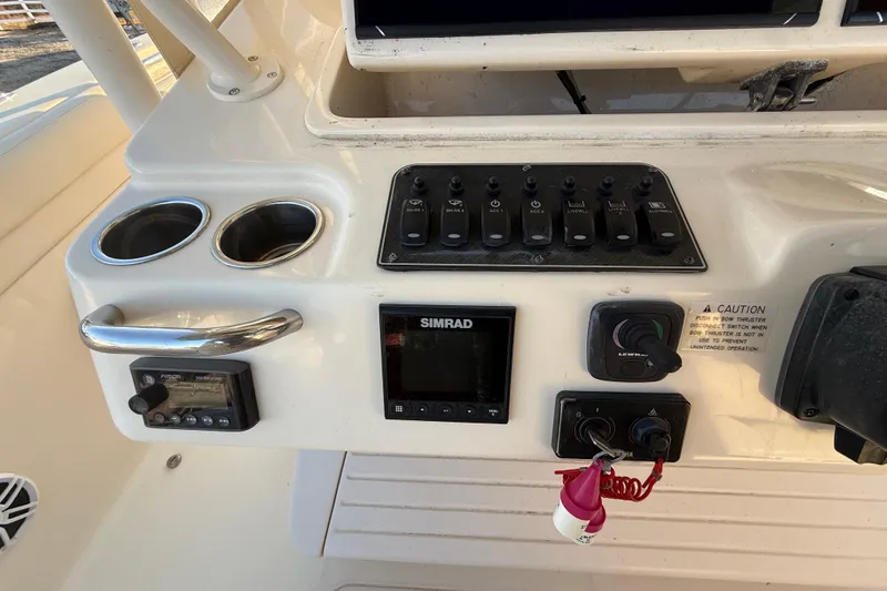 Slide: The Image of Control panel of 2017 Grady-White Canyon 336 boat with switches and electronics. - 24