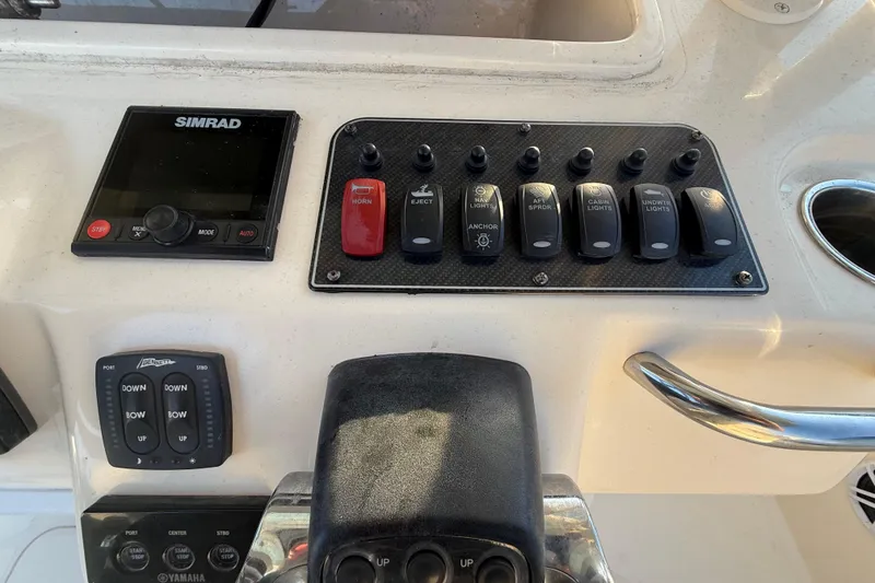 Slide: The Image of Control panel of a 2017 Grady-White Canyon 336 boat with Simrad display and switches. - 25