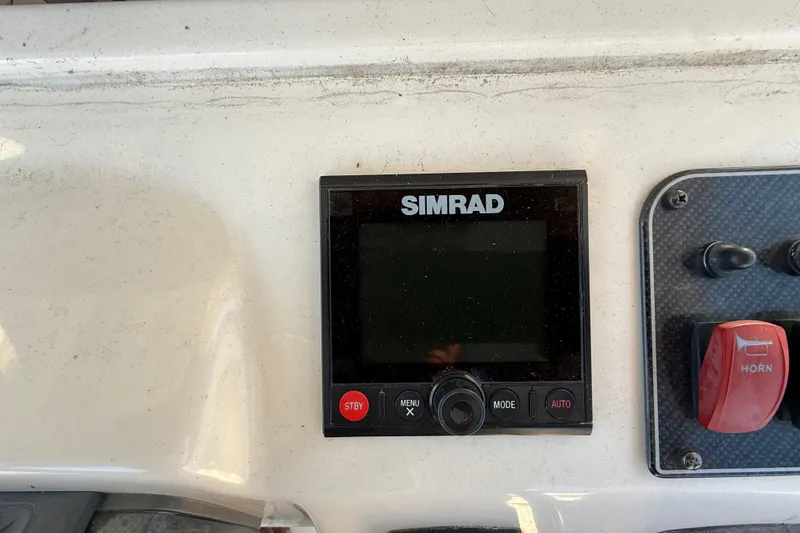 Slide: The Image of Simrad control panel on 2017 Grady-White Canyon 336 boat dashboard. - 27