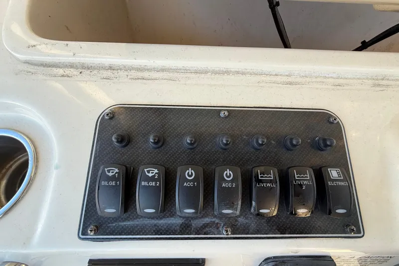 Slide: The Image of Control panel of a 2017 Grady-White Canyon 336 boat with labeled switches. - 28