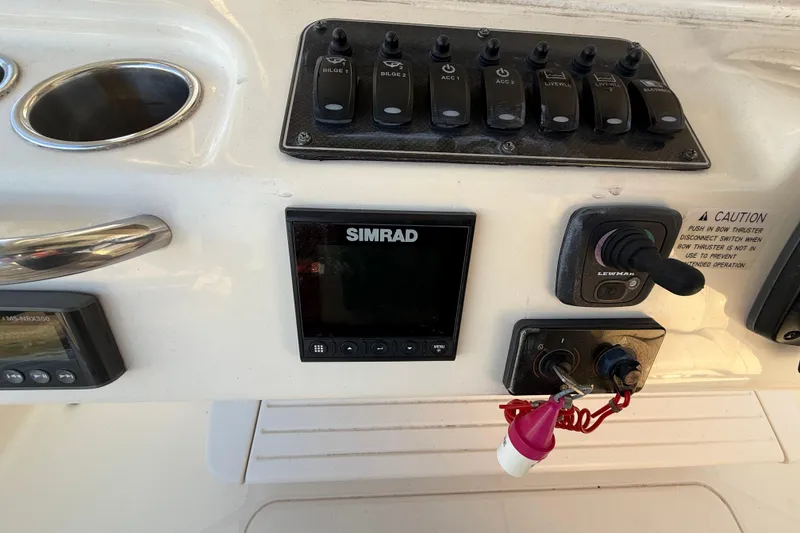 Slide: The Image of Control panel of 2017 Grady-White Canyon 336 boat with Simrad display and switches. - 29