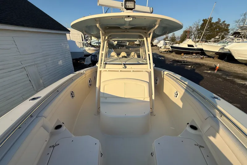Slide: The Image of 2017 Grady-White Canyon 336 boat, spacious deck, parked outdoors, clear sky. - 35