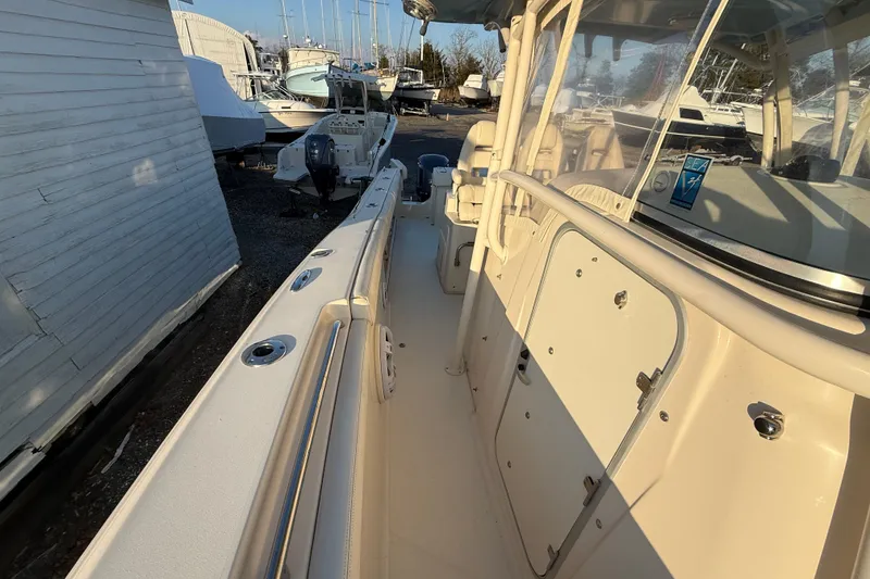 Slide: The Image of 2017 Grady-White Canyon 336 boat interior with seating and storage, docked outdoors. - 36