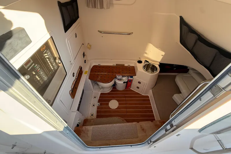 Slide: The Image of 2017 Grady-White Canyon 336 cabin interior with wood flooring and compact amenities. - 37