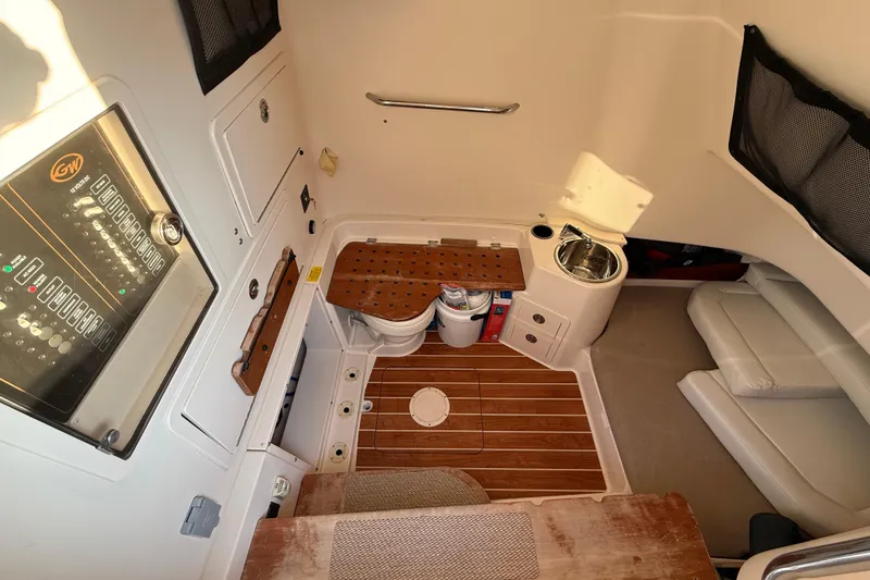 Slide: The Image of 2017 Grady-White Canyon 336 cabin interior with wood flooring and compact amenities. - 38