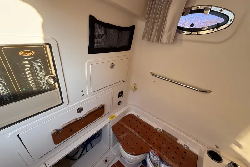 Slide: The Image of 2017 Grady-White Canyon 336 cabin interior with control panel and porthole. - 40