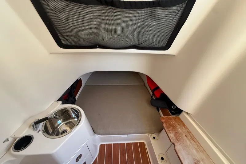 Slide: The Image of 2017 Grady-White Canyon 336 cabin interior with sink and cushioned seating area. - 42