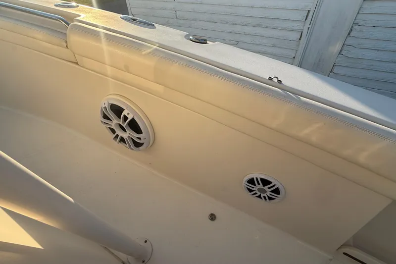 Slide: The Image of 2017 Grady-White Canyon 336 boat interior with speakers and cushioned seating. - 51