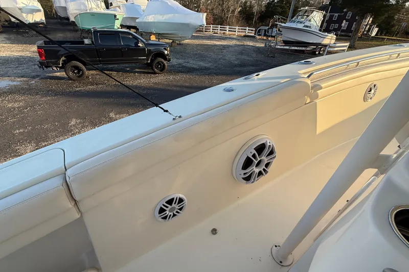 Slide: The Image of 2017 Grady-White Canyon 336 boat interior with speakers, parked truck in background. - 52