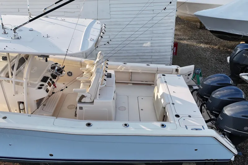 Slide: The Image of 2017 Grady-White Canyon 336 boat with spacious deck and triple outboard engines. - 6