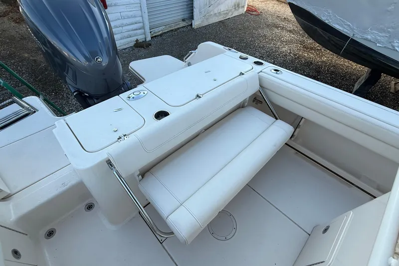 Slide: The Image of 2023 Grady-White Fisherman 236 boat interior with foldable seating and storage compartments. - 11