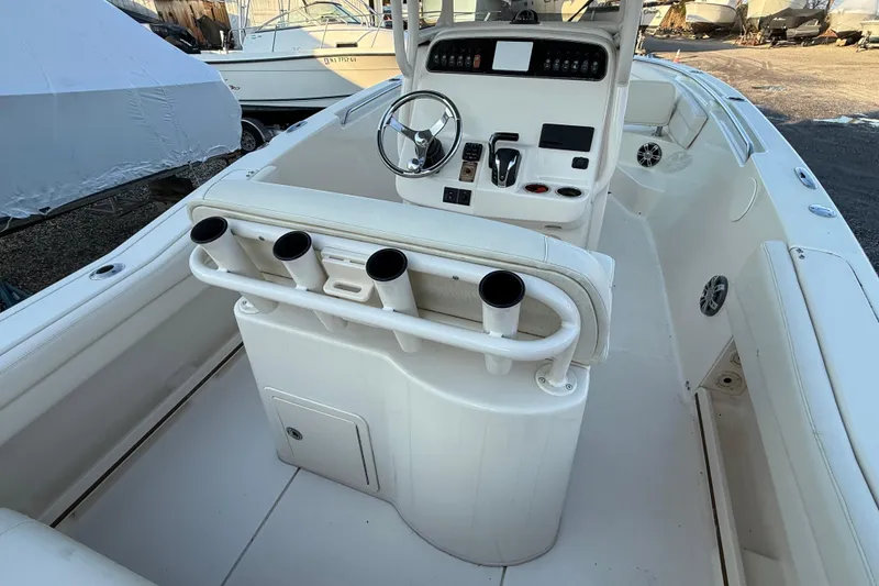Slide: The Image of 2023 Grady-White Fisherman 236 boat interior with steering console and rod holders. - 13