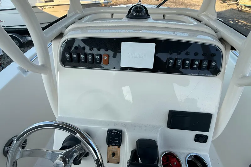 Slide: The Image of 2023 Grady-White Fisherman 236 dashboard with steering wheel and control panel. - 15