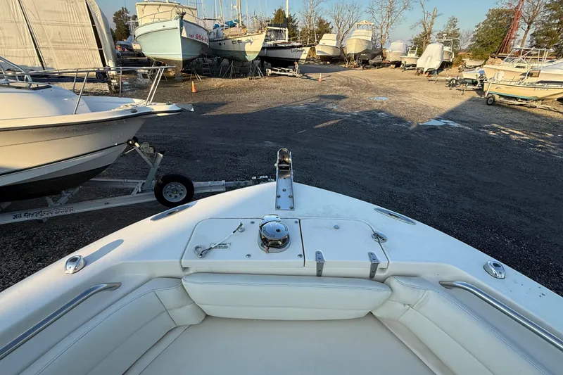 Slide: The Image of 2023 Grady-White Fisherman 236 boat in a marina with other vessels. - 18