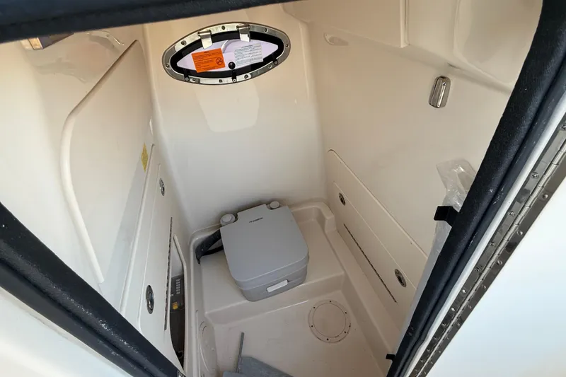 Slide: The Image of 2023 Grady-White Fisherman 236 boat interior with compact marine toilet. - 21