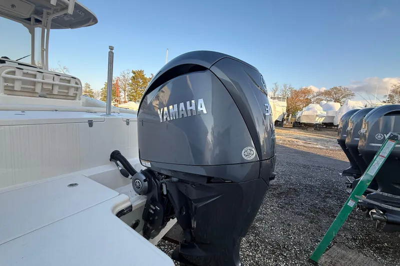 Slide: The Image of 2023 Grady-White Fisherman 236 with Yamaha outboard motor in a boatyard setting. - 24