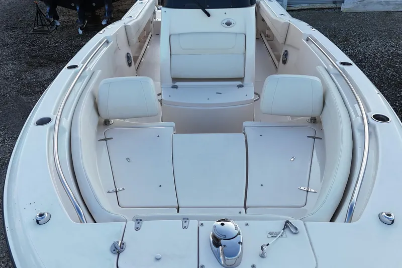 Slide: The Image of 2023 Grady-White Fisherman 236 boat interior with white seating and storage compartments. - 8