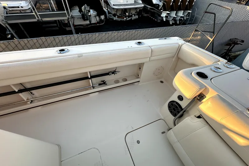 Slide: The Image of 2019 Grady-White Canyon 336 boat interior with rod holders and seating. - 12