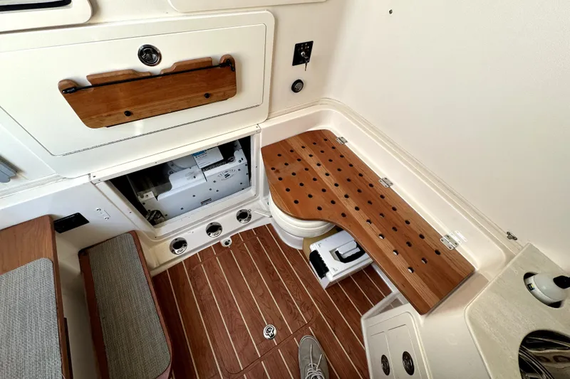 Slide: The Image of 2019 Grady-White Canyon 336 interior with wooden accents and storage compartments. - 16