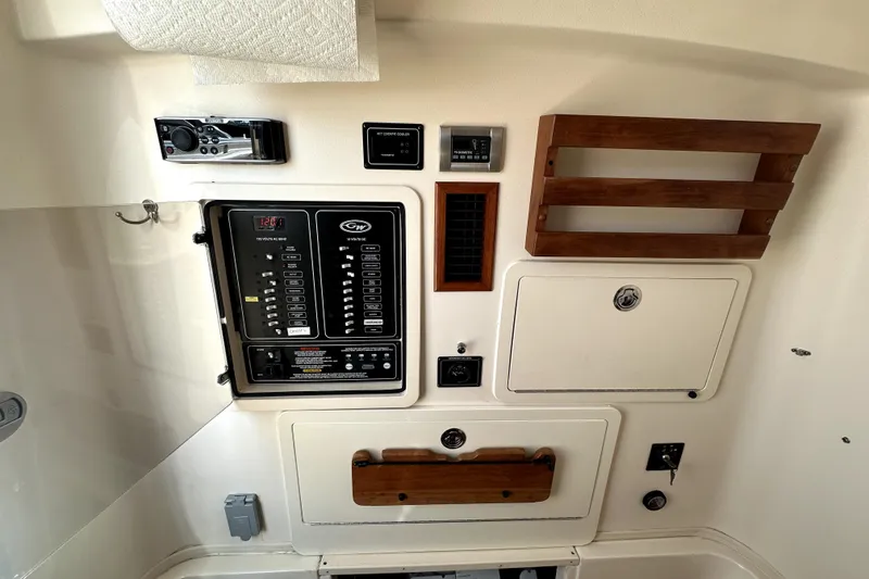 Slide: The Image of 2019 Grady-White Canyon 336 boat interior control panel with wooden accents. - 18