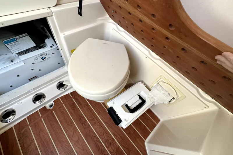 Slide: The Image of 2019 Grady-White Canyon 336 boat interior with toilet and storage compartment. - 19