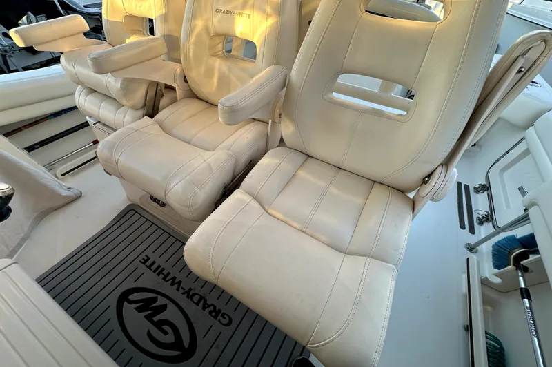 Slide: The Image of 2019 Grady-White Canyon 336 boat interior with plush seating and branded floor mat. - 22