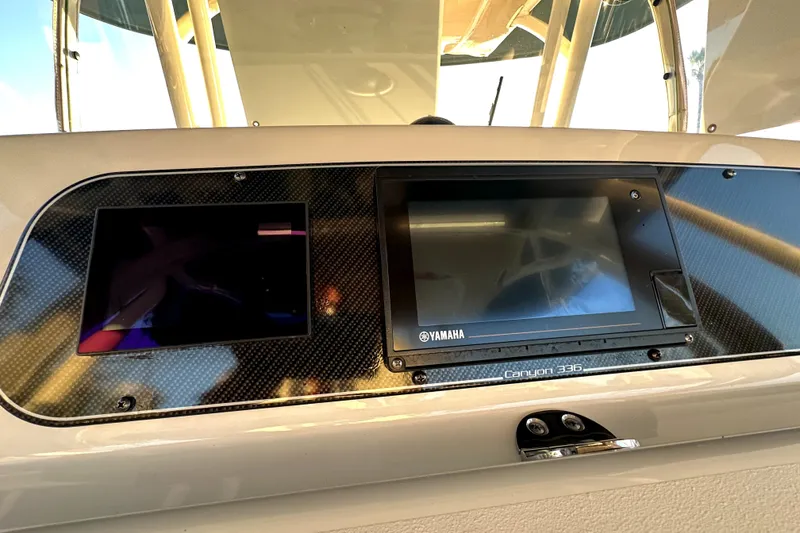 Slide: The Image of 2019 Grady-White Canyon 336 dashboard with Yamaha display screens. - 27