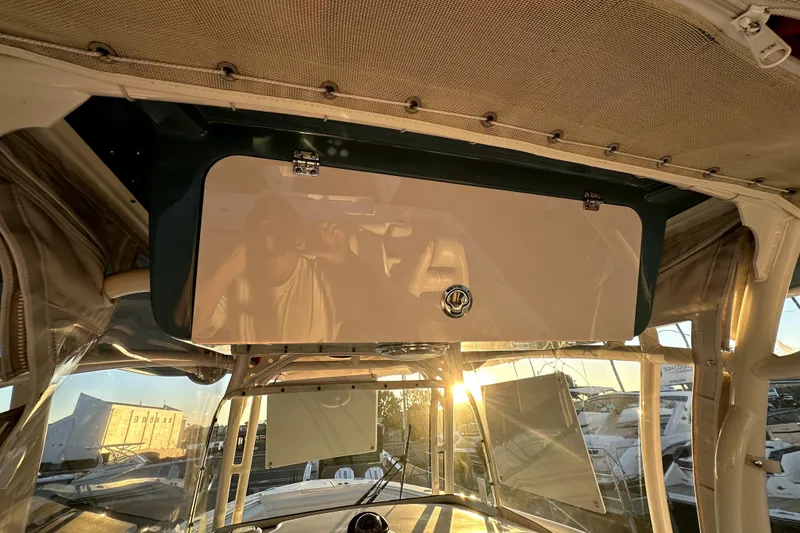 Slide: The Image of 2019 Grady-White Canyon 336 boat interior with sunset reflection on storage compartment. - 28